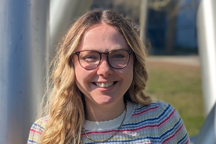 Photo of Marlen Neubert standing outdoors smiling on a sunny day.